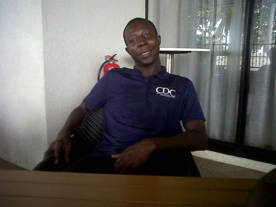 Gibrilla Kamara sitting at a table smiling